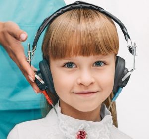 a girl wearing headphones for a hearing test